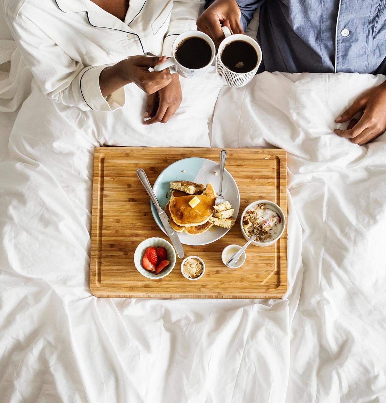 Couple having Breakfast in Bed Couple having Breakfast in Bed